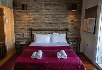 a bed with two pairs of shoes on it at Sigma Sauna Nest in Athens
