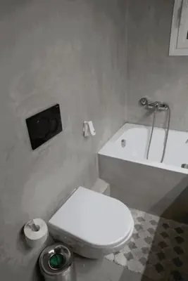 a bathroom with a white toilet and a bath tub at Sigma Sauna Nest in Athens