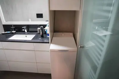 a small bathroom with a sink and a washer at Sigma Sauna Nest in Athens