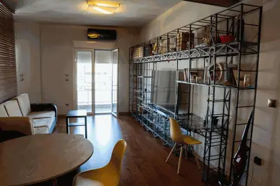 a living room with a fire place in the wall at Sigma Sauna Nest in Athens