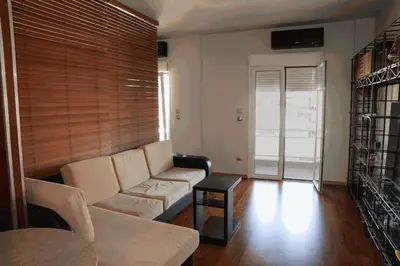 a living room with a couch and a table at Sigma Sauna Nest in Athens