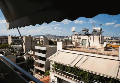 a view of a city from the balcony of a building at Sigma Sauna Nest in Athens