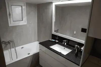 a bathroom with a sink and a mirror and a tub at Sigma Sauna Nest in Athens