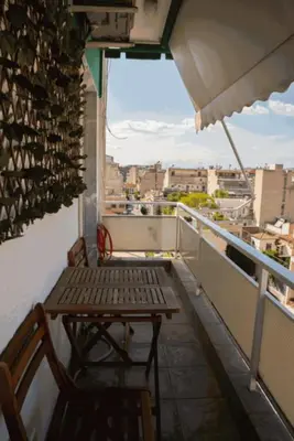 a balcony with a bench and a view of a city at Sigma Sauna Nest in Athens