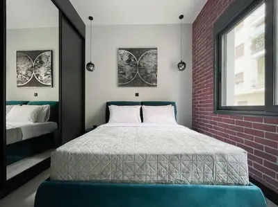 a bedroom with a bed and a brick wall at Lucky New Home #01 VIPGreece in Athens