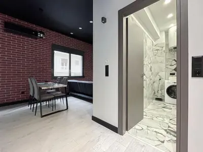 a dining room with a table and a brick wall at Lucky New Home #01 VIPGreece in Athens