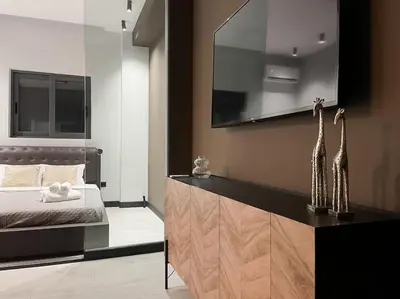 a bedroom with a bed and a dresser with giraffes on it at Lucky Central Home #22 VIPGreece in Athens