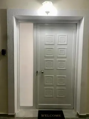 a silver door with a light on top of it at Nikos Apartment in Spáta