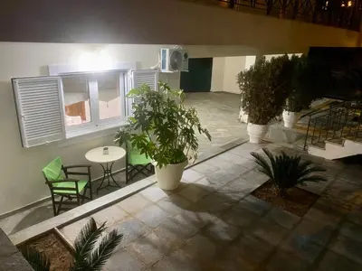 a room with plants and a table and chairs at Nikos Apartment in Spáta