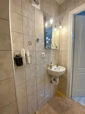 a bathroom with a sink and a shower at Nikos Apartment in Spáta