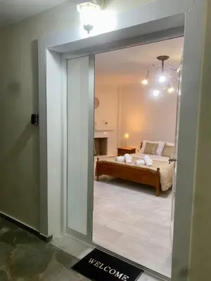 a view of a bedroom with a bed through a mirror at Nikos Apartment in Spáta
