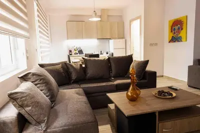 a living room with a couch and a table at FKVILLAS-K-1 in Piraeus