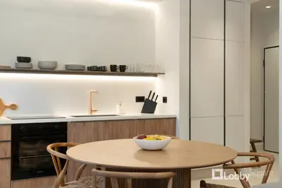 a kitchen with a table with a bowl of fruit on it at Muse Apartment by LobbySquare in Athens