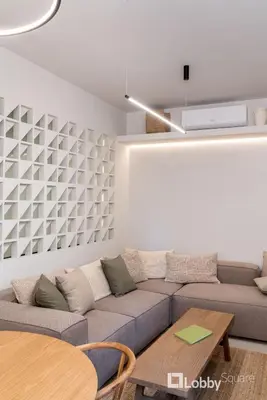 a living room with a couch and a table at Muse Apartment by LobbySquare in Athens