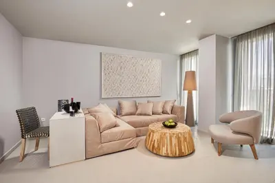 a living room with a couch and a table at CW Athens Riviera Suite in Athens