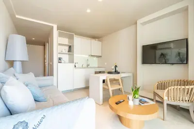 a living room with a couch and a table at CW Athens Riviera Suite in Athens
