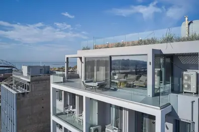 a building with a glass roof with a patio at CW Athens Riviera Suite in Athens