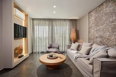 a living room with a couch and a table at CW Athens Riviera Suite in Athens