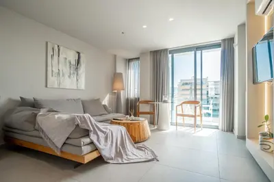 a living room with a couch and a table at CW Athens Riviera Suite in Athens