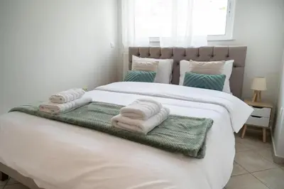 a bedroom with a large white bed with towels on it at Breathtaking view apartment in Glyfada (AS_D1) in Athens
