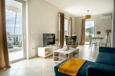 a living room with a blue couch and a tv at Breathtaking view apartment in Glyfada (AS_D1) in Athens