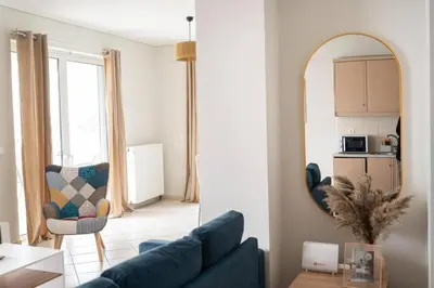 a living room with a blue couch and a mirror at Breathtaking view apartment in Glyfada (AS_D1) in Athens