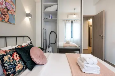 a bedroom with a bed with towels on it at Zappa 2-Bedroom Apartment in Athens in Athens