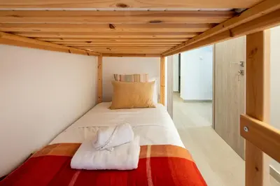 a bed in a small room with a wooden ceiling at Zappa 2-Bedroom Apartment in Athens in Athens