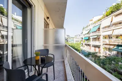 a balcony with a table and chairs on a building at Zephyr 3-Bedroom Apartment in Athens in Athens