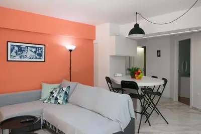 a living room with a couch and a table at Gly3 65m2 sunshine oasis in Glyfada in Athens