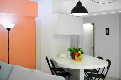 a room with a table with a bowl of fruit on it at Gly3 65m2 sunshine oasis in Glyfada in Athens