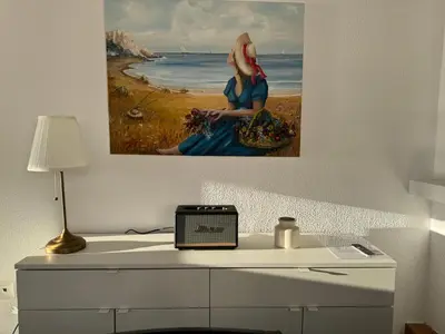 a painting of a woman sitting on a desk at Traditional Seaview Maisonette in Saronida