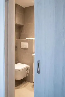 a bathroom with a toilet and a sink at Traditional Seaview Maisonette in Saronida