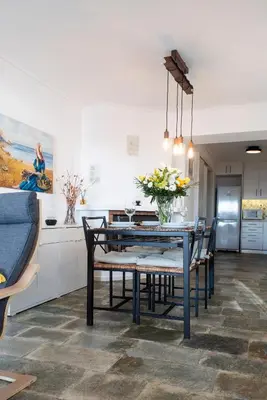 a kitchen and dining room with a table and chairs at Traditional Seaview Maisonette in Saronida
