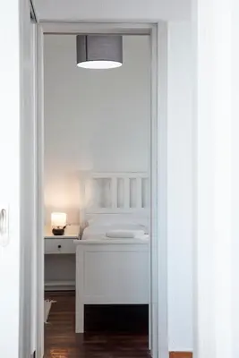 a bedroom with a bed and a table with a lamp at Traditional Seaview Maisonette in Saronida