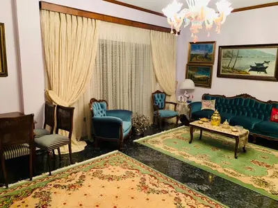 a living room with a blue couch and chairs at House Mario’s airport 2 in Spáta