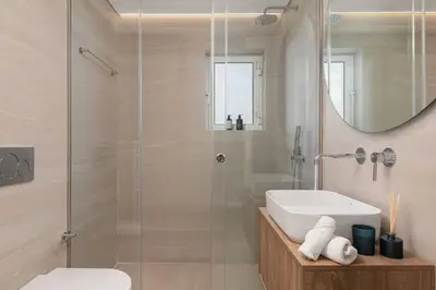 a bathroom with a sink and a shower with a mirror at 2-BDR SV Elegance Luxury Apt with Shared pool in Athens