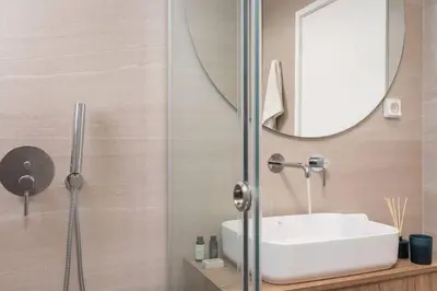 a bathroom with a sink and a mirror at 2-BDR SV Elegance Luxury Apt with Shared pool in Athens