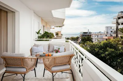a balcony with a table and chairs and a view at 2-BDR SV Elegance Luxury Apt with Shared pool in Athens