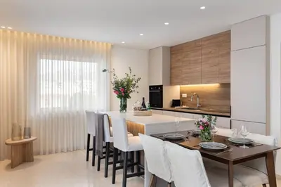 a kitchen and dining room with a table and chairs at 2-BDR SV Elegance Luxury Apt with Shared pool in Athens