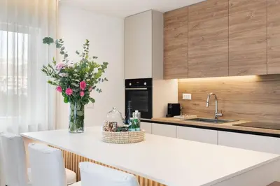 a kitchen with a counter with a vase of flowers on it at 2-BDR SV Elegance Luxury Apt with Shared pool in Athens