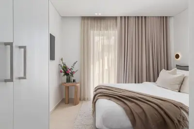 a white bedroom with a bed and a window at 2-BDR SV Elegance Luxury Apt with Shared pool in Athens