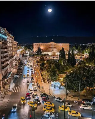 a busy city street filled with cars at night at Syntagma studio in Athens