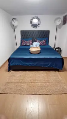 a bedroom with a blue bed with a blue blanket at Syntagma studio in Athens