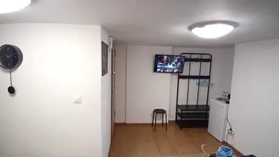 a living room with a tv on the wall at Syntagma studio in Athens