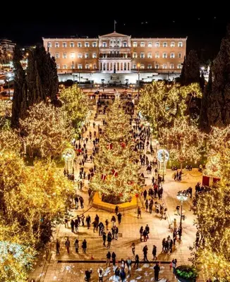 a christmas tree in a plaza in front of a building at Syntagma studio in Athens