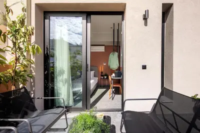 a glass door to a balcony with a living room at Bonnie Athens by Nin&Bau in Athens