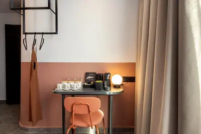a table with a chair and a coffee maker on it at Bonnie Athens by Nin&Bau in Athens