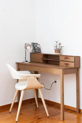 a wooden desk with a white chair next to it at zen penthouse in exarchia in Athens