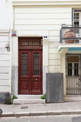 a red door on the side of a building at zen penthouse in exarchia in Athens